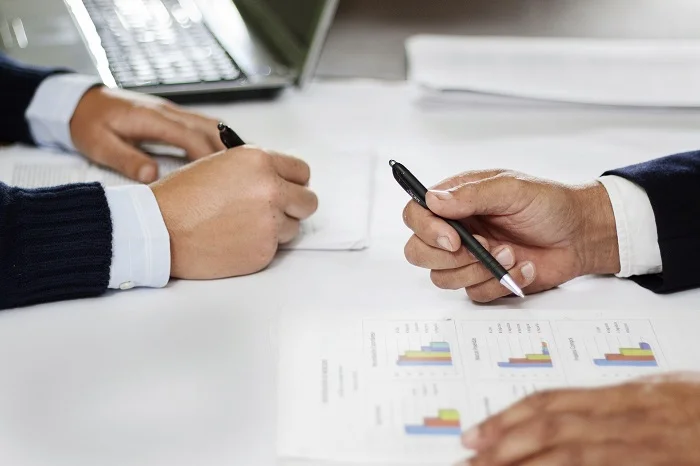 Advisors reviewing strategic reports with a client